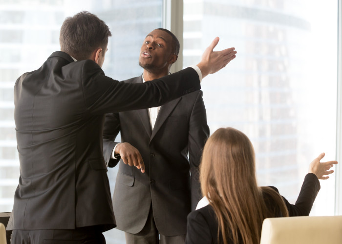 People in a meeting gesturing in an argument. Image by yanalya on Freepik